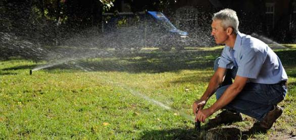 Irirgation contractor in San Rafael adjusts sprinkler head